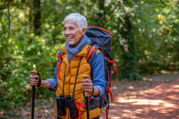 istock Woman with hiking poles in forest. 1181286071