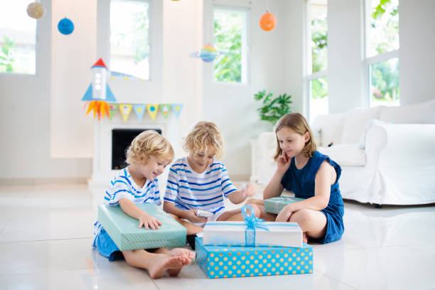 istock Space theme kids birthday party. Boy with present. 1181286278