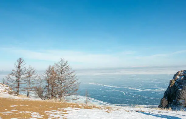 Photo of Landscape of frozen Lake Baikal in winter with cloud and blue sky; view point from cape at Olkhon island.