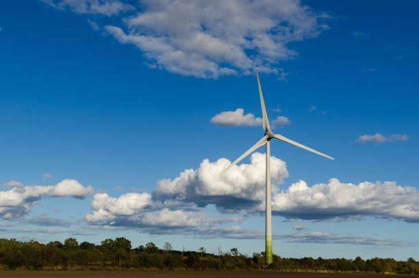 istock Windmill by a blue sky with white clouds by fall season 1181288720