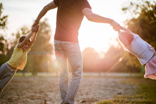 istock Father is spinning kids around 1181294205