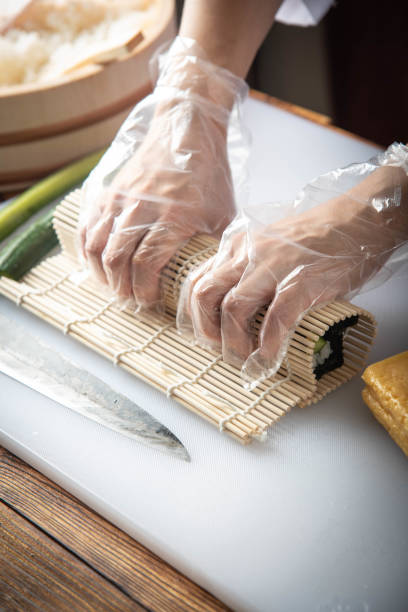 istock sushi chef making roll sushi with cucumber and egg 1181303358