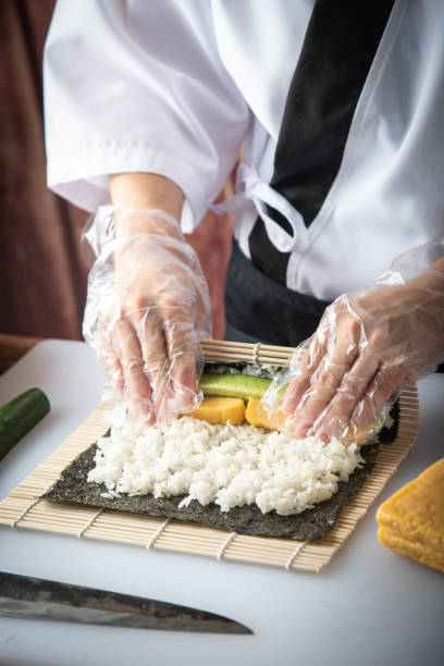 istock sushi chef making roll sushi with cucumber and egg 1181303603