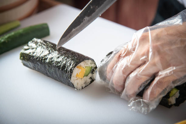 istock sushi chef making roll sushi with cucumber and egg 1181303773
