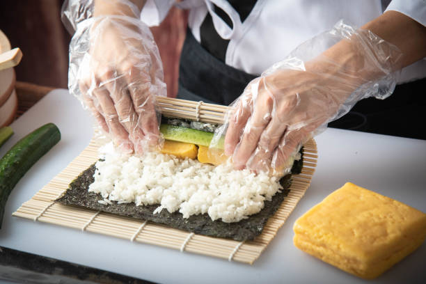 istock sushi chef making roll sushi with cucumber and egg 1181303825