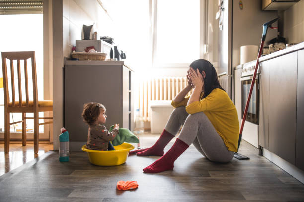 istock Young mother with a baby girl doing housework 1181303837