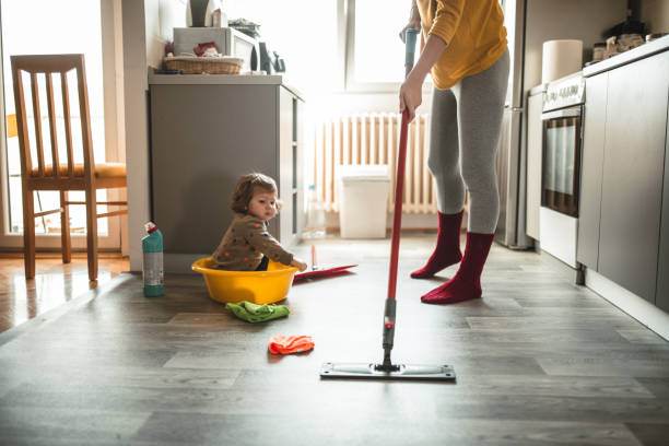 istock Young mother with a baby girl doing housework 1181306229