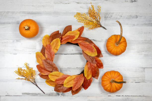 istock Fall background with pumpkins and magnolia wreath 1181307093