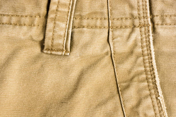 istock clothing items stonewashed cotton fabric texture with seams, clasps, buttons and rivets, macro 1181307536