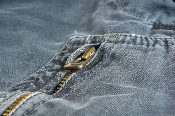 istock clothing items stonewashed cotton fabric texture with seams, clasps, buttons and rivets, macro 1181307644