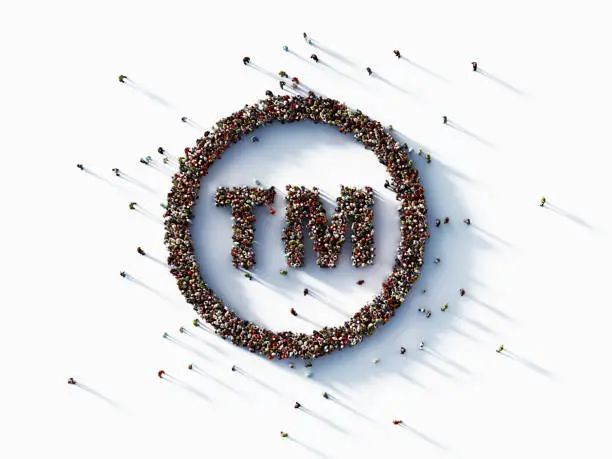 Human crowd forming trademark symbol on white background. Horizontal composition with copy space.