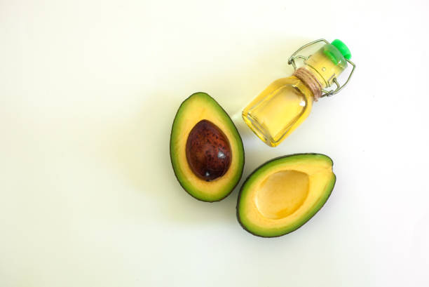 istock Avocado and avocado oil in bottle on white background. Top view. Copy space. 1181310736