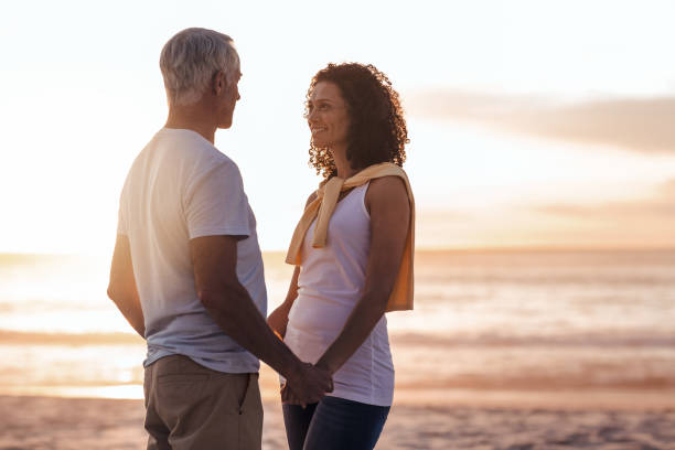 istock Couple looking at each other on a beach during sunset 1181311790