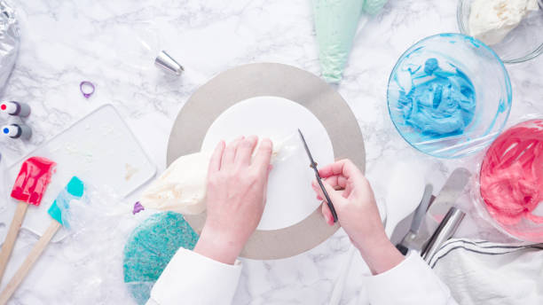 istock Stacking cake layers to create the round vanilla cake 1181313179