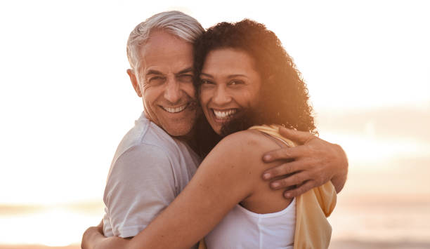 istock Affectionate mature couple hugging on a beach at sunset 1181314085