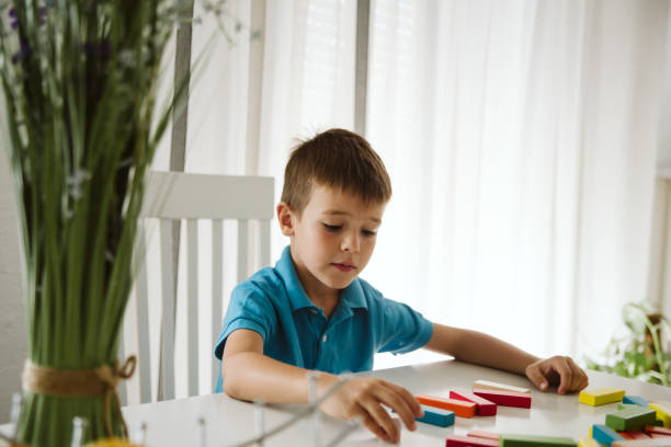istock Boy is playing with toys at home. 1181314884