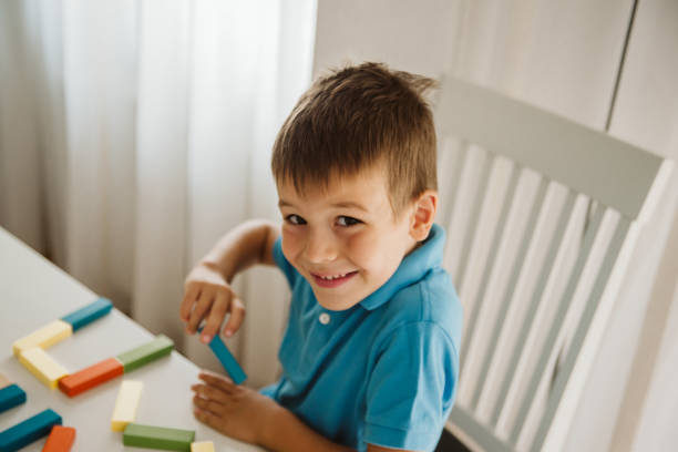 istock Boy is playing with toys at home. 1181315016