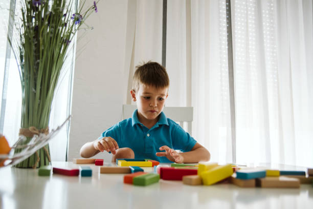 istock Boy is playing with toys at home. 1181315058
