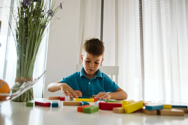 istock Boy is playing with toys at home. 1181315080