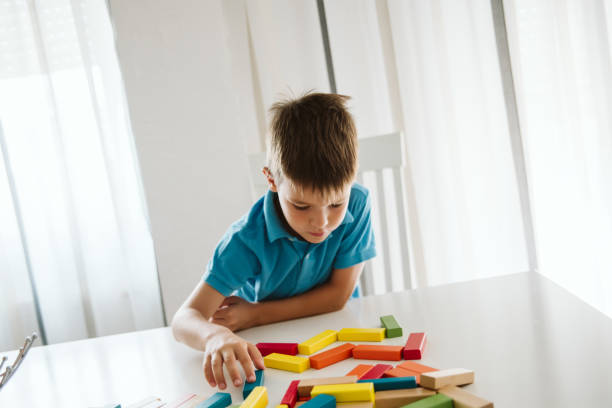 istock Boy is playing with toys at home. 1181315129