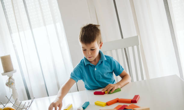 istock Boy is playing with toys at home. 1181315150