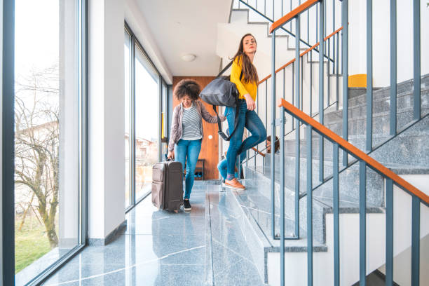 istock Multi-ethnic female friends moving up on staircase 1181315294
