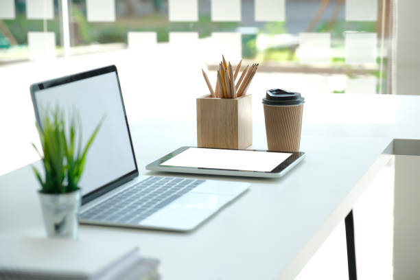 istock computer tablet pencil coffee cup on office desk. workplace interior 1181315318