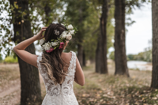 Beautiful bride in wedding dress with floral crown