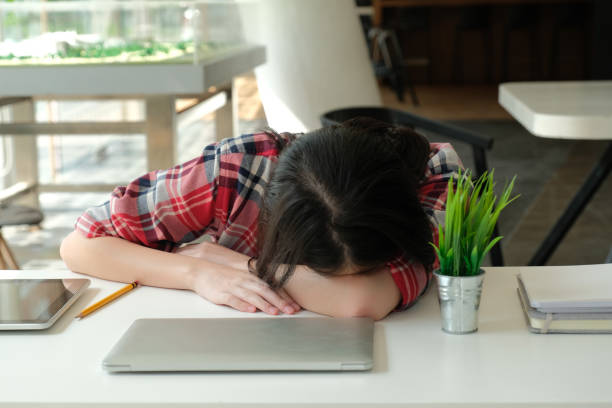istock woman sleeping at workplace. girl tired from hard work 1181315336