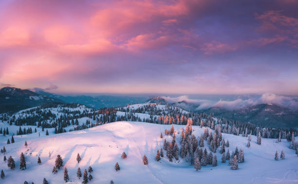 Colorful Sunset Idyllic winter landscape at sunset. View from above. snowcapped mountain stock pictures, royalty-free photos & images