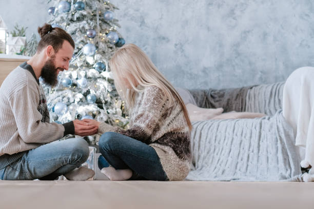 istock romantic winter holidays couple cozy interior 1181315395