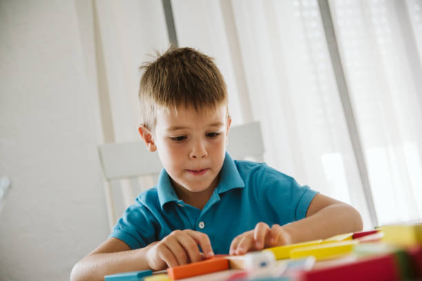 istock Boy is playing with toys at home. 1181315491