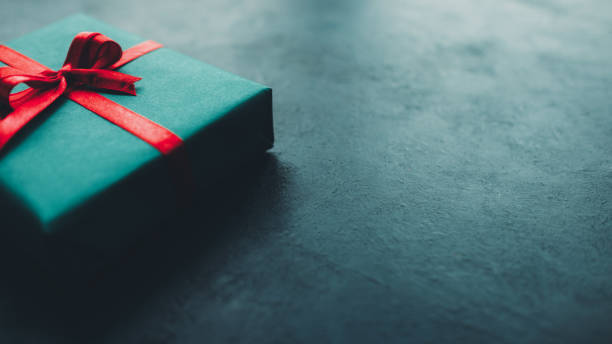 istock birthday present gift box teal blue background 1181315555