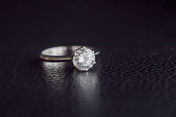 istock Close up diamond ring jewelry on black leather background 1181315655