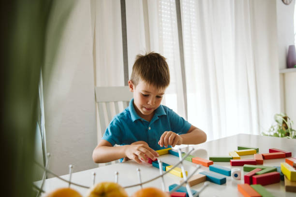 istock Boy is playing with toys at home. 1181316374