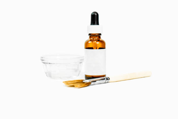 Blank drip bottle for cosmetic chemical peel formula, with dish and applicator makeup  brush, for beauty treatments, with white blank label. Room for text (copy). Blank drip bottle for cosmetic chemical peel formula, with dish and applicator makeup  brush, for beauty treatments, with white blank label. Room for text (copy). facial chemical peel stock pictures, royalty-free photos & images