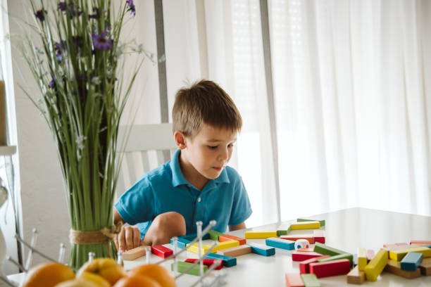 istock Boy is playing with toys at home. 1181316777