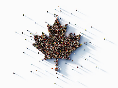 Human crowd forming a maple leaf on white background. Horizontal composition with copy space.