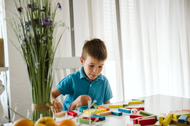 istock Boy is playing with toys at home. 1181316803