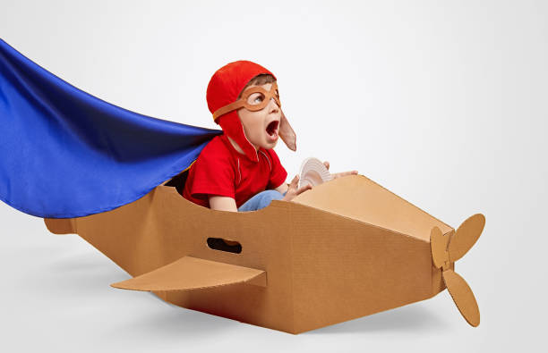 istock Amazed little pilot in carton plane 1181317078
