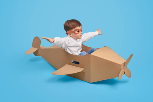 istock Little aviator flying in carton plane 1181317084