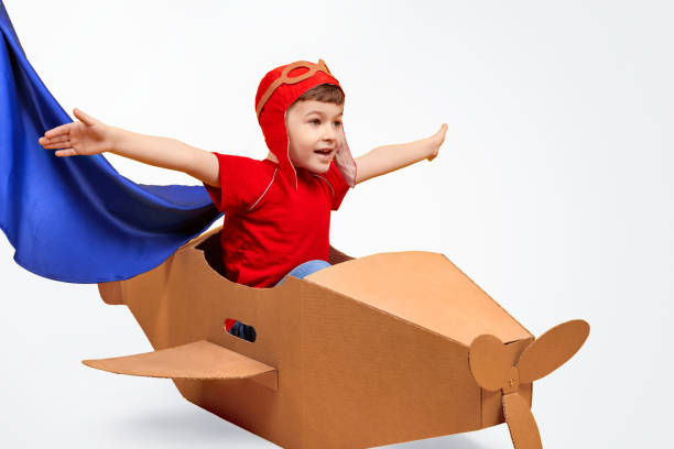 Little pilot flying in carton plane