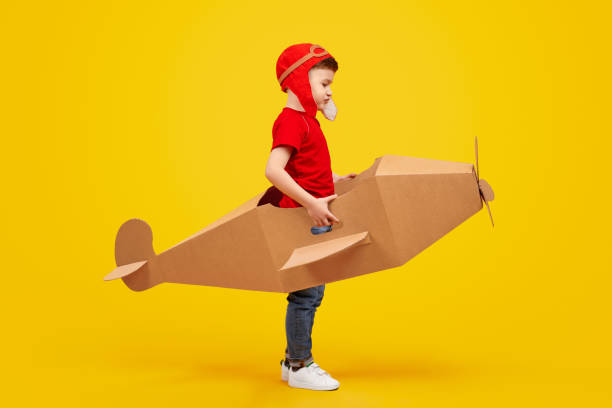 istock Little aviator in cardboard plane 1181317098