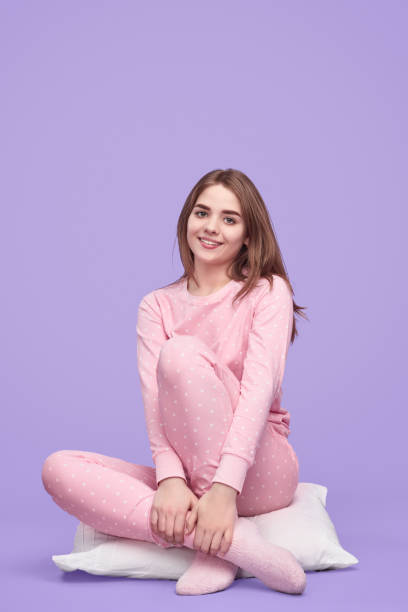 istock Smiling teenager sitting on pillow 1181317172