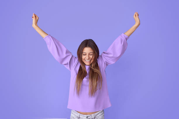 Joyful pretty young woman stretching arms