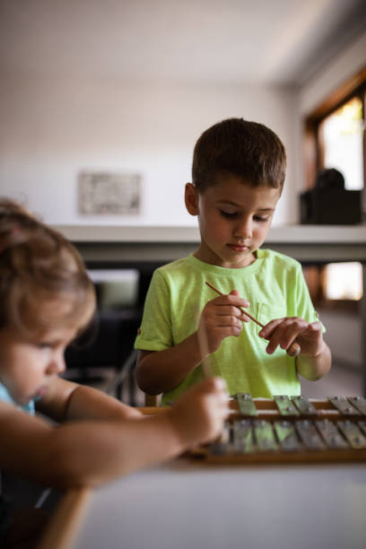 istock Brother and sister playing on xylophone 1181321274