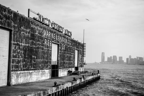 Black and White image taken of the old historic Marine and Aviation pier on the Hudson River in New York City USA.