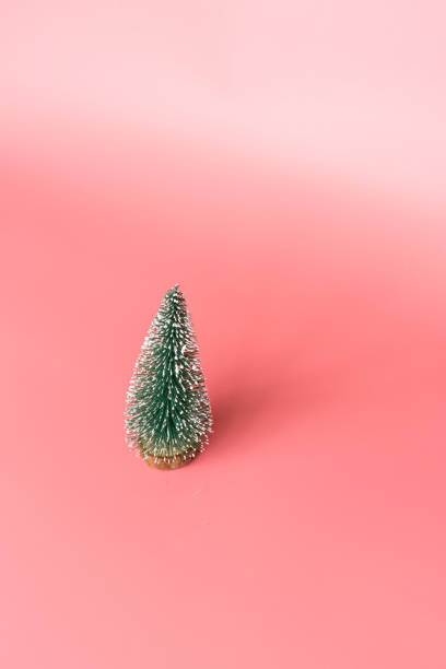 istock Christmas tree made in pink background with copy space for text. Minimal xmas concept. New year 2020 celebration. Mockup, template, greeting card 1181324598