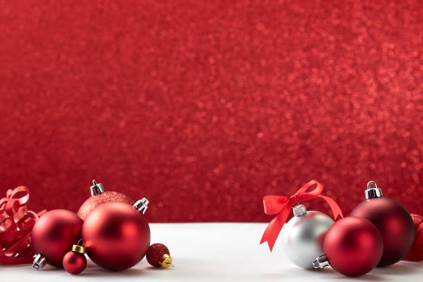 istock many christmas balls on white table red wall 1181325303