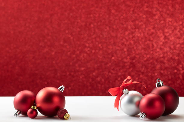 istock many christmas balls on white table red wall 1181325308